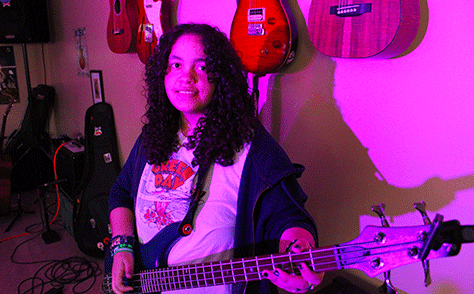 teenage girl playing guitar